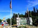 Welcome sign w/ flags, insignia in Placerville, CA
